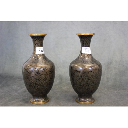 142 - A pair of 20th century black and gilt cloisonne vases, each 23cm high.