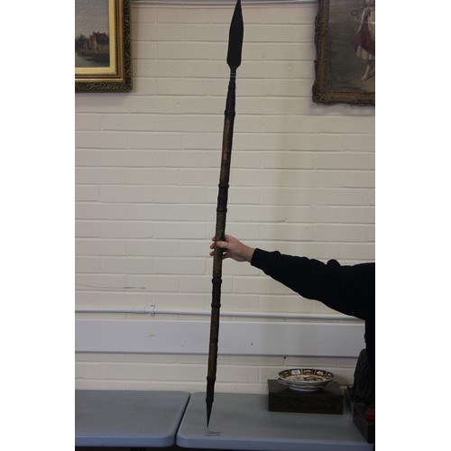 113 - A tribal spear with monkey skin covered shaft, and pointed terminal, 155cm long, overall, possibly I... 