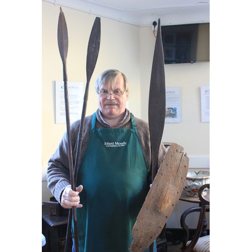 3 - A small wood parrying shield, possibly Zulu, two assegai spears, 191 cm, and 194cm long, respectivel... 