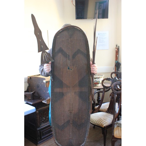 4 - A Congolese Ngandu shield, a small bow with two arrow shafts, and a Congolese currency sword, 75cm l... 