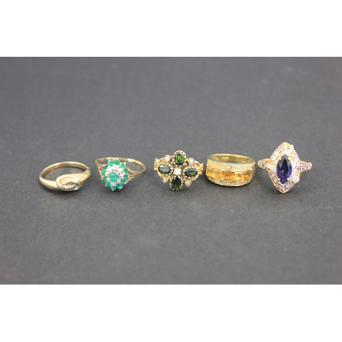 9 - A 9ct gold cluster dress-ring, set central emerald, ten small emeralds and eight small diamonds a.f.... 