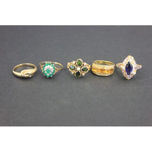 9 - A 9ct gold cluster dress-ring, set central emerald, ten small emeralds and eight small diamonds a.f.... 