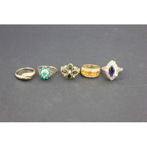 9 - A 9ct gold cluster dress-ring, set central emerald, ten small emeralds and eight small diamonds a.f.... 