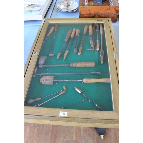 19 - A framed collection of soldering irons, circa 1880-1945, in a display case, 90cm x 60cm.