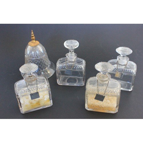 27 - A set of four early 19th century glass scent bottles, with some cut decoration, with four silver lab... 