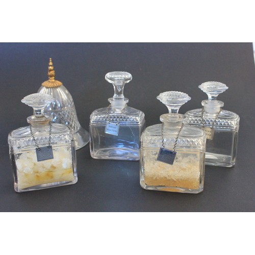 27 - A set of four early 19th century glass scent bottles, with some cut decoration, with four silver lab... 