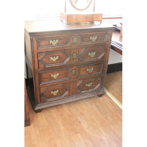 34 - A late 17th century oak chest of four long graduated drawers, with geometric moulded fronts, on four... 