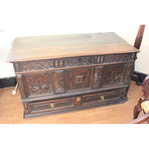 35 - A Charles II oak mule chest, with planked top, the front with floral and foliate carved panels, abov... 