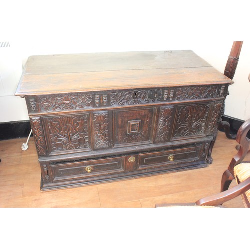 35 - A Charles II oak mule chest, with planked top, the front with floral and foliate carved panels, abov... 