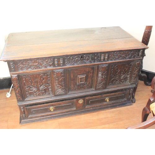 35 - A Charles II oak mule chest, with planked top, the front with floral and foliate carved panels, abov... 