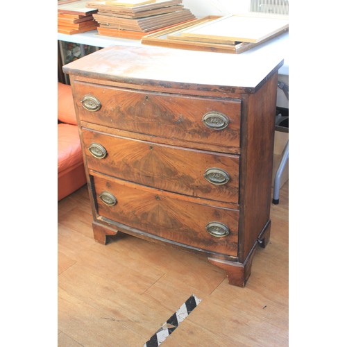 38 - A 19th century mahogany bow fronted chest of three long drawers, with oval plate handles, on bracket... 