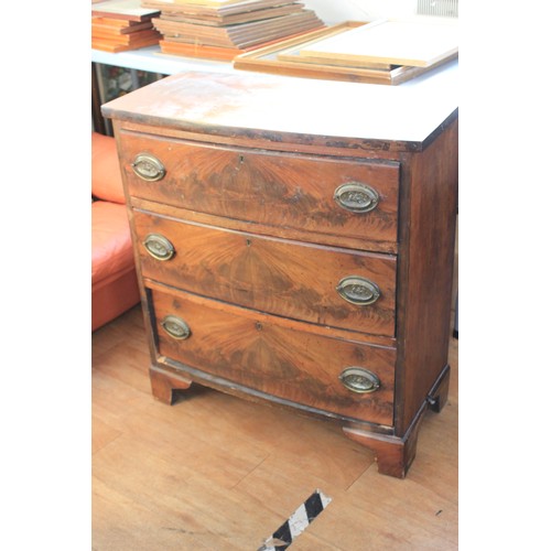 38 - A 19th century mahogany bow fronted chest of three long drawers, with oval plate handles, on bracket... 