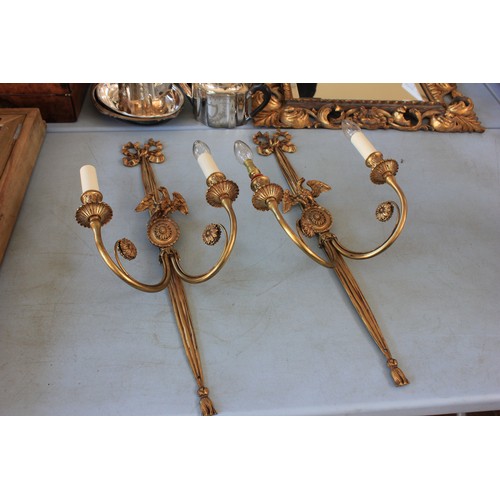 40 - A pair of gilt metal two branch wall lights, with oval pattern bird crests, and ribbon tops, 72cm hi... 