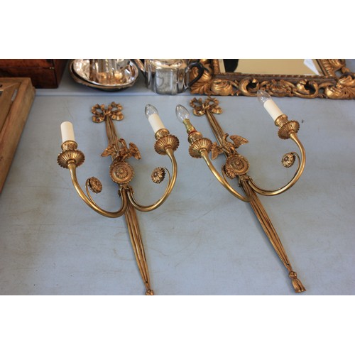 40 - A pair of gilt metal two branch wall lights, with oval pattern bird crests, and ribbon tops, 72cm hi... 