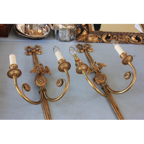 40 - A pair of gilt metal two branch wall lights, with oval pattern bird crests, and ribbon tops, 72cm hi... 