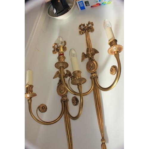 40 - A pair of gilt metal two branch wall lights, with oval pattern bird crests, and ribbon tops, 72cm hi... 