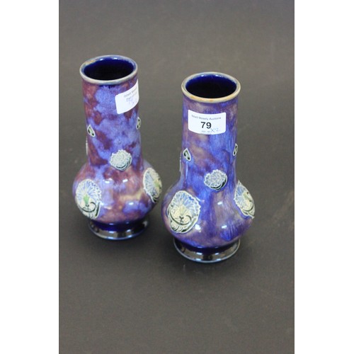 79 - A pair of Royal Doulton bottle form vases, with cylindrical necks, 19cm high and a Royal Doulton pea... 