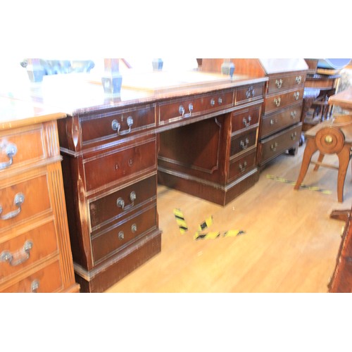 129 - A reproduction mahogany pedestal desk, fitted nine drawers, 154cm wide.