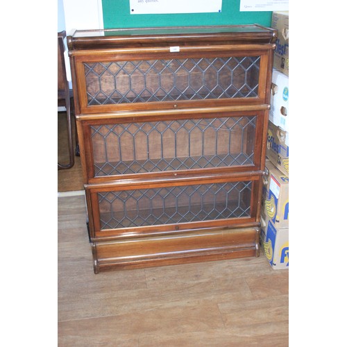 140 - A mahogany Globe Wernicke three tier bookcase, with leaded glass doors, 86cm wide x 114cm high.