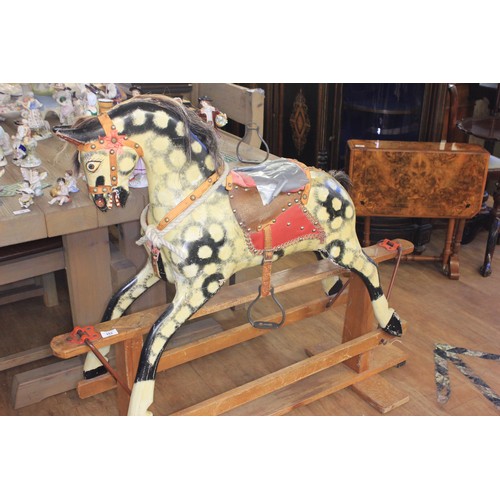 153 - A 20th century child's rocking horse, on pale beech base, 113cm long x 101cm high, a.f