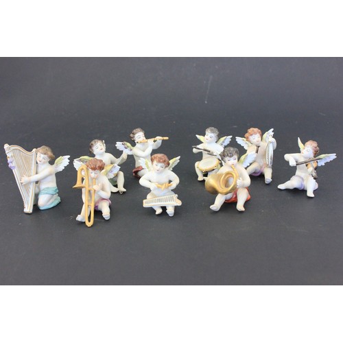 285 - Nine small Sitzendorf figures of cherubs, as musicians, each approx. 7cm high (9).