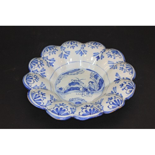 288 - A 19th century Delft blue and white dish, with scalloped edge, 25cm in diameter, a.f.