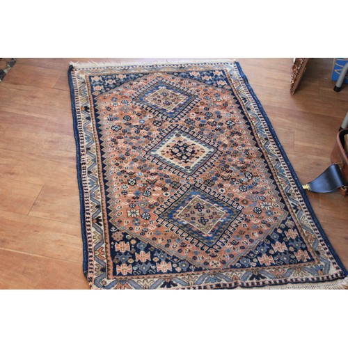 290 - A small Caucasian rug, with three central medallions, on rose pink ground, wide border, 84cm x 137cm... 