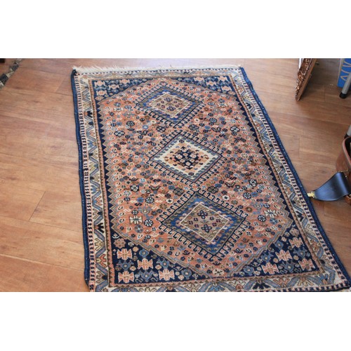 290 - A small Caucasian rug, with three central medallions, on rose pink ground, wide border, 84cm x 137cm... 