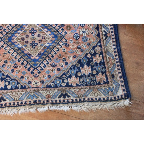 290 - A small Caucasian rug, with three central medallions, on rose pink ground, wide border, 84cm x 137cm... 