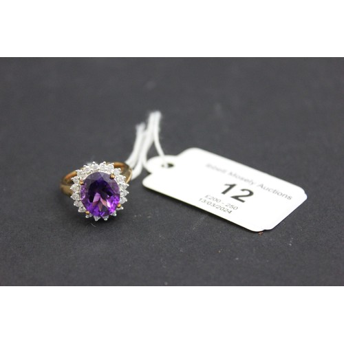 12 - A 9ct gold dress-ring, set large central amethyst and twenty tiny diamonds.