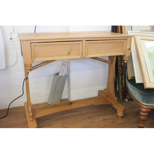 16 - A Victorian stripped pine writing table, fitted two drawers, 84cm wide.