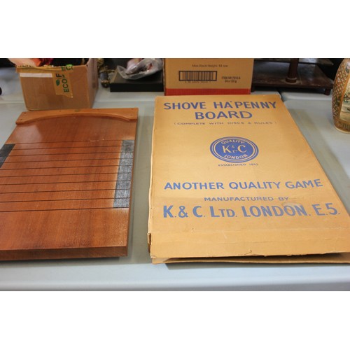 29 - A shove ha'penny board, by K and C Ltd, in original box, with discs and chalk.