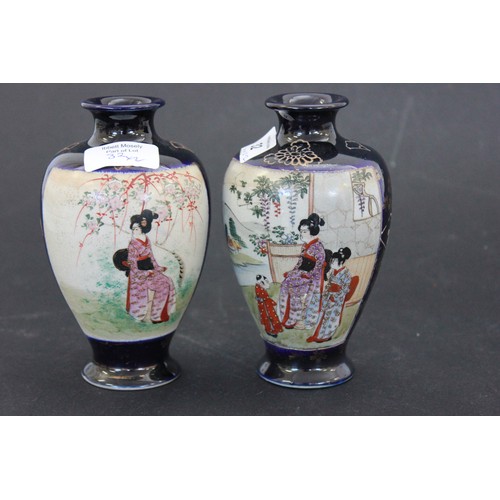 32 - A pair of Japanese satsuma ware blue ground vases, decorated figural panels, each 15cm high.