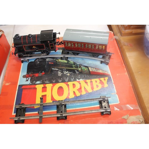 270 - A Hornby 'o' gauge clockwork train set, comprising:- an 0-4-0 tank locomotive, coaches, and track, l... 