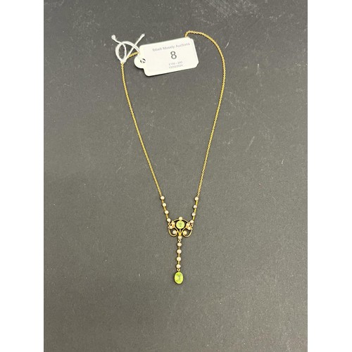 8 - A 9ct gold pendant, set a peridot, a pale blue topaz, and twenty seed pearls, on metal slender link ... 