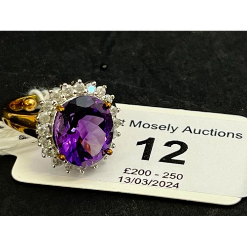 12 - A 9ct gold dress-ring, set large central amethyst and twenty tiny diamonds.