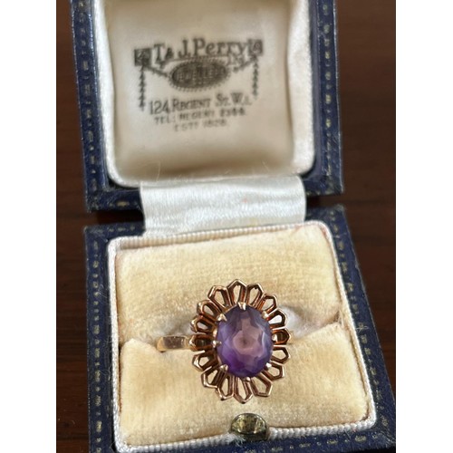 52 - 9ct gold dress ring set a central amethyst, flower head design.