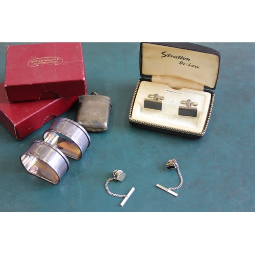 19 - An Edward VII silver vesta case, Birmingham, 1901, with inscription, two silver napkin rings, Birmin... 