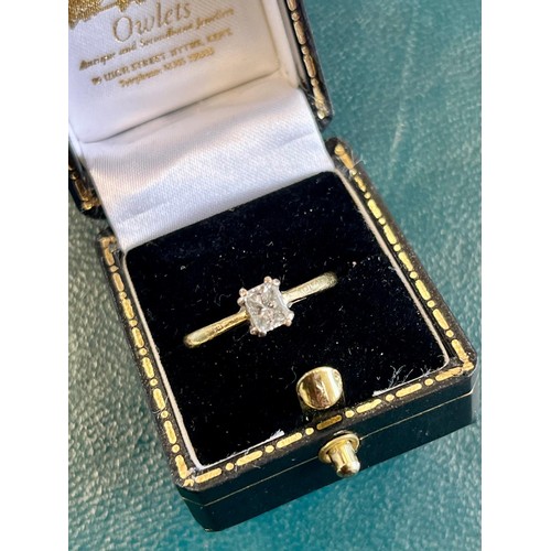 27 - An 18ct gold diamond solitaire dress-ring, emerald cut stone, size M, boxed.