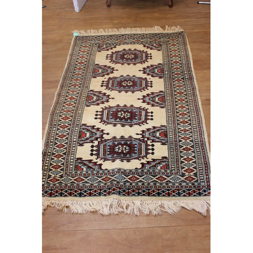 44 - A Caucasian rug with multiple medallions on cream ground, wide border, 93cm by 148cm.