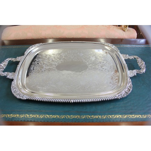 49 - A silver-plated two handled rectangular tray with engraved decoration, gadrooned and foliate scroll ... 