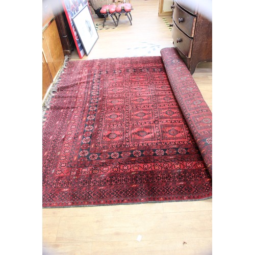 60 - A Turkish rug, with rectangular medallions, on red ground, wide multibanded border, approx. 300cm x ... 