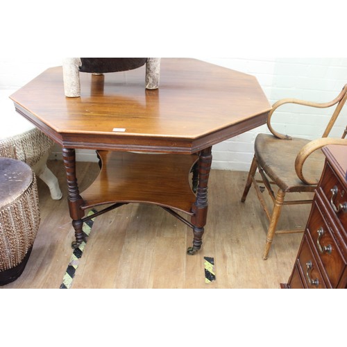 61 - A Victorian stained and carved beech octagonal centre table, on turned and ringed legs, united by an... 