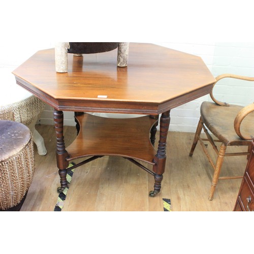 61 - A Victorian stained and carved beech octagonal centre table, on turned and ringed legs, united by an... 