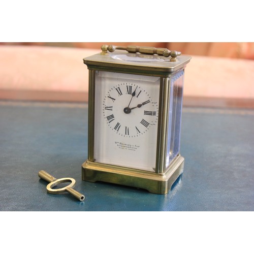 110 - A gilt-brass carriage clock with white enamelled dial, inscribed 'WM Bruford and Son Eastbourne and ... 