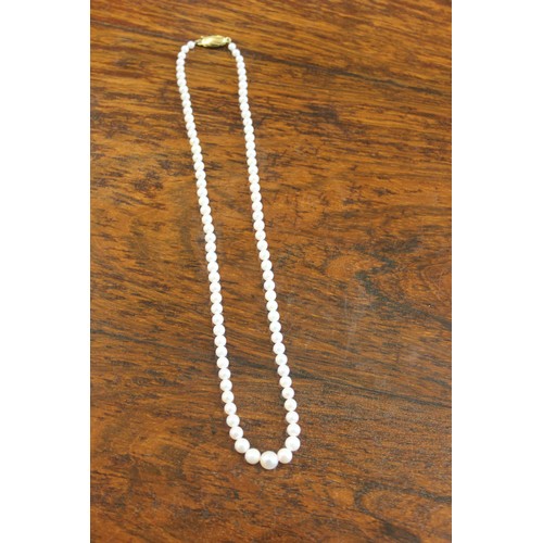 51 - A single strand Akoya Japanese cultured pearl necklace, 44cm long, with yellow-metal clasp (marks in... 