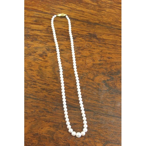 51 - A single strand Akoya Japanese cultured pearl necklace, 44cm long, with yellow-metal clasp (marks in... 