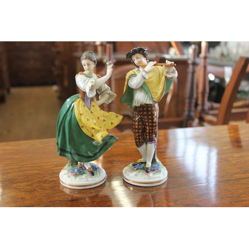 58 - A pair of Rudolfstadt porcelain figures of youth as musician and girl dancing, each 20cm high, sligh... 