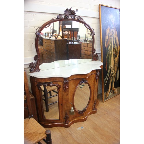 64 - A Victorian walnut credenza with marble top & mirrored back, above three mirrored panel doors, 135cm... 