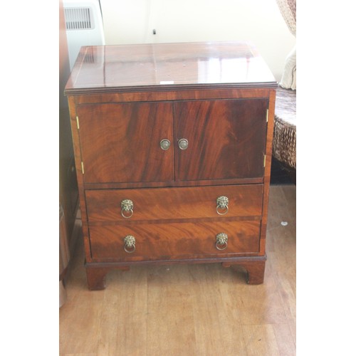 66 - A reproduction mahogany bedside linen cabinet fitted two doors above two drawers, 63cm wide.